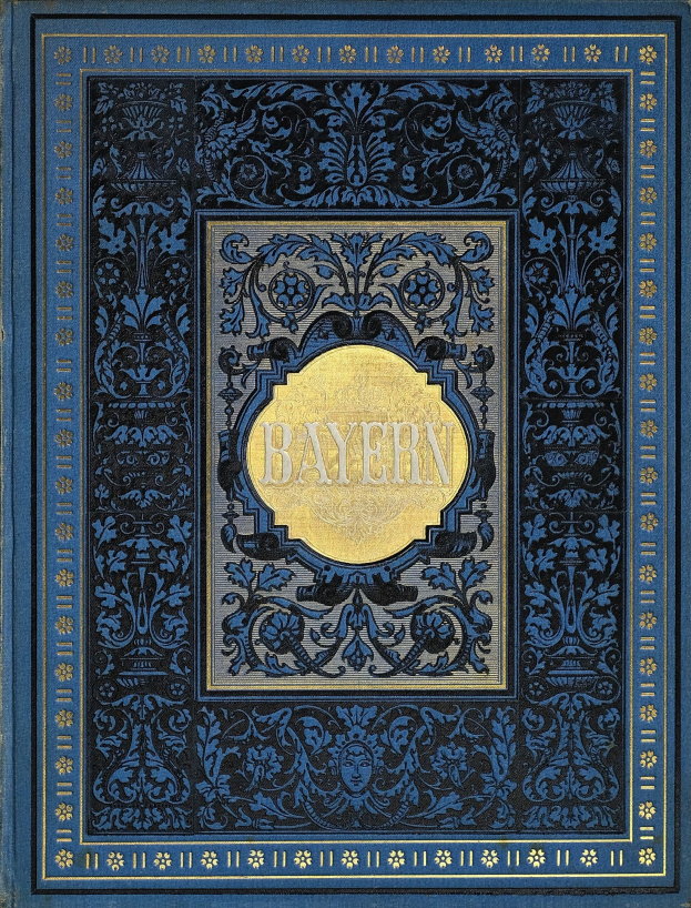 Ein blau-goldenes Buch mit dem Wort "Bayern" darauf, verziert mit aufwändigen Ornamenten.